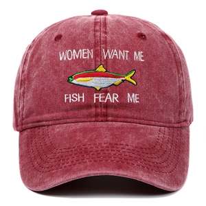 Detail of vintage washed red baseball cap with funny fishing embroidery and high quality texture