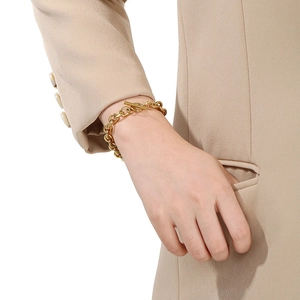 Detailed shot of a gold-tone stainless steel chain bracelet with a stylish OT toggle clasp