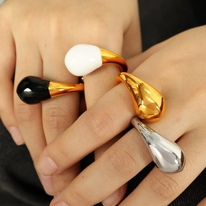 French style teardrop enamel open rings in black, white, gold, and silver on model hands