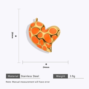 Macro detail of heart-shaped leopard pendant in stainless steel with 18k gold plating