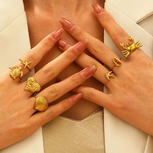 Golden 7-piece stainless steel ring set with sea turtle and starfish ocean designs