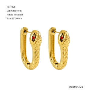 Detailed view of snake-shaped earrings in 18k gold plated stainless steel with red stone