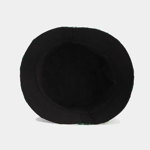 Reversible bucket hat featuring green clover print and black lining for sun protection