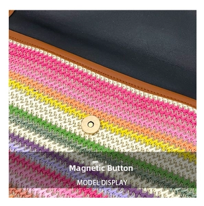 Detail of colorful woven straw bag featuring magnetic snap closure and leather trim