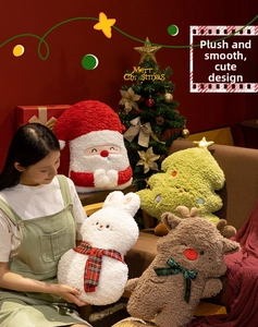 Detail of plush Christmas pillows with Santa and reindeer made of soft sherpa fleece fabric