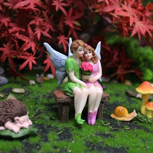 Garden fairy couple resin ornaments with miniature hedgehog and mushroom accents