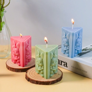 Detailed relief of rabbit on colorful triangular candle molds for Easter decor