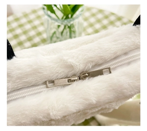 Detail of premium silver metal double zippers on soft white plush backpack for girls