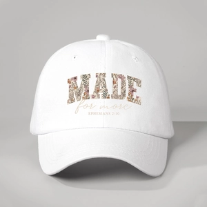 Detailed close-up of MADE for more floral print on a white cotton baseball cap