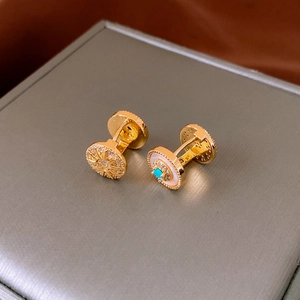 Detail of vintage gold-plated sunburst earrings with zircon and turquoise on a jewelry box
