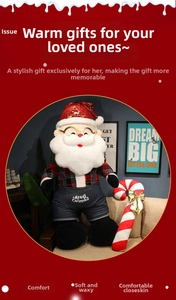 Detail of Santa plush toy in overalls with white Merry Christmas embroidery on the pocket