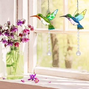 Beautiful hummingbird crystal suncatchers hanging by a sunny window for vibrant garden decor