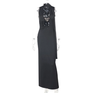 Detail of sexy backless dress showing halter neck with gold chain and flowing ribbons