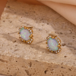 Detailed close-up of 18K gold plated oval opal earrings with crystal halo on stone base