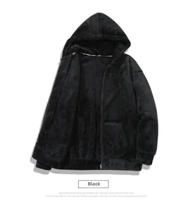 Detail of black faux fur hooded jacket with zip closure and ribbed cuffs texture