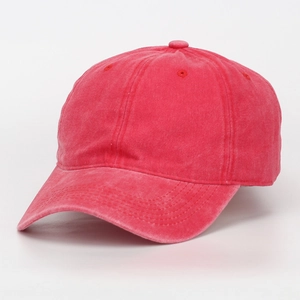 Detail of washed red cotton baseball cap showing vintage texture and 6-panel stitching