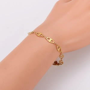 18K gold plated stainless steel pig nose chain bracelet shown on a model hand