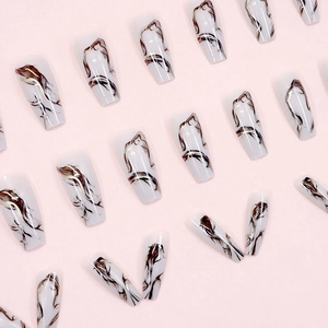 Long ballerina press-on nails with white marble ink pattern and gold accents