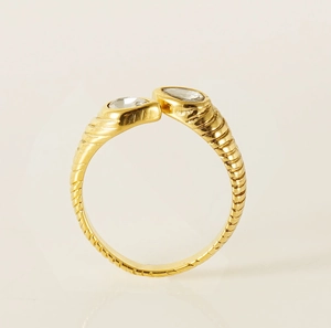 Macro shot of 18K gold plated twisted band ring with sparkling teardrop zircon stones