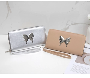 Detail of silver and beige long wallets featuring liquid metal butterfly decor and wrist strap