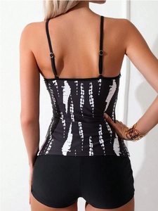 Rear view of tankini top with white brushstroke print and black boyshorts bottom