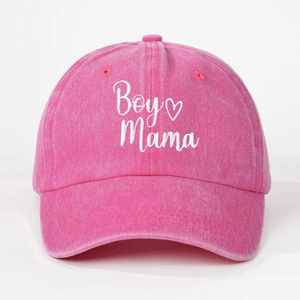 Close-up of white Boy Mama embroidery and heart pattern on pink washed cotton cap