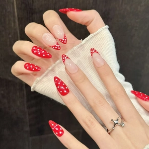 Red and white polka dot press-on nails in long almond shape for daily wear