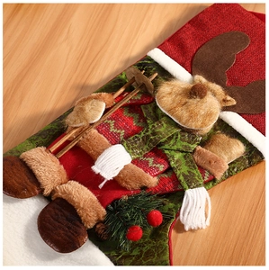 Close-up of Christmas stocking with 3D reindeer, pine cones and festive berries detail