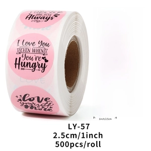 Detail of pink Valentine's Day sticker roll with 8 diverse circular designs and 1-inch labels