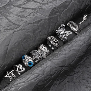 Macro detail of vintage silver animal rings featuring owl and snake gothic designs