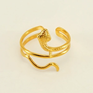 Detailed close-up of a gold snake-shaped ring featuring unique dotted surface texture