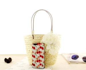 Mini bolso de paja con flor blanca y teléfono para comparar el tamaño del producto