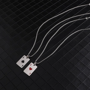 Detail of spade and heart ace poker card pendants on titanium steel necklace chains