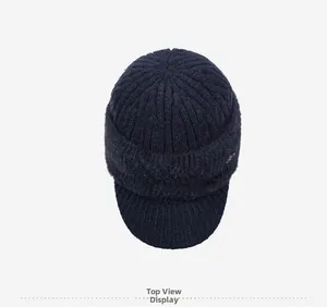 Top view of navy blue knitted elder men winter hat with warm fleece trim and small metal logo