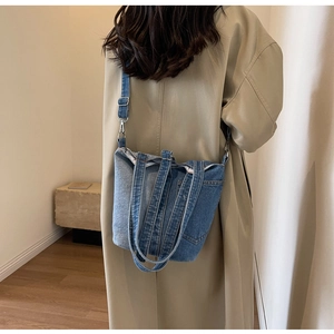 Detail of the vintage denim patchwork tote bag with adjustable shoulder straps and handles