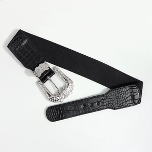Detail of black belt buckle with silver butterfly rhinestone decoration and crocodile texture