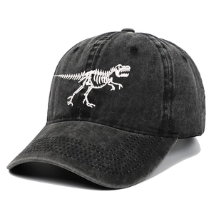 Close-up of dinosaur skeleton embroidery on washed black cotton baseball cap