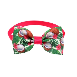 Macro shot of tropical bow tie with coconut, hibiscus, and palm leaf patterns
