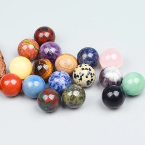 Close-up of polished natural crystal spheres including amethyst, tiger eye and quartz