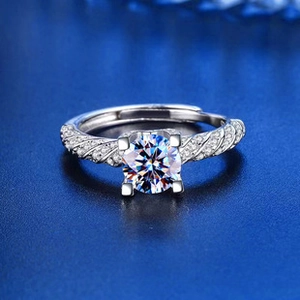 Close-up of a snowflake cut engagement ring with twisted pavé band on a blue background