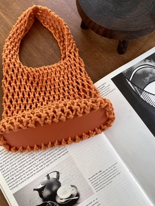 Close-up of orange hand-woven cotton rope tote bag with mesh hollow design detail