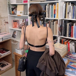 Detailed back view of a black ballet style hair bow clip with long ribbons and a silk texture
