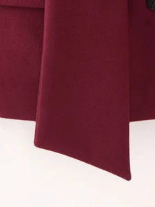 Macro shot of dark red wool fabric texture with sharp diagonal cut on a wide belt detail