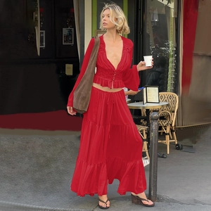 Detail of red chiffon tiered maxi skirt and lace cardigan with frill hem and tie waist