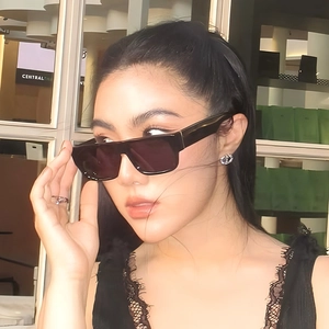 Chic black oversized square sunglasses for men and women in a modern urban setting