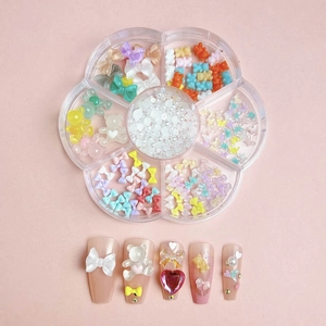 Close-up of 7-grid flower storage box with resin bows, bears and pearls for nail art