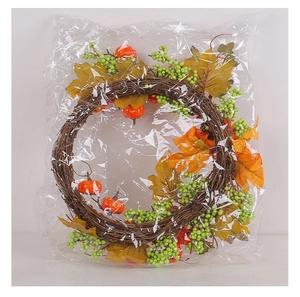 Detail view of autumn harvest wreath with orange pumpkins and maple leaves in packaging
