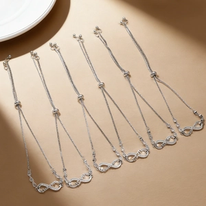 Set of 6 infinity silver bracelets featuring adjustable sliding clasps and polished finish