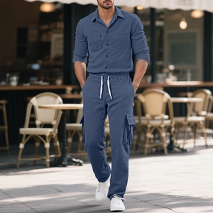 Men's navy corduroy shirt and cargo pants set in a stylish outdoor cafe setting