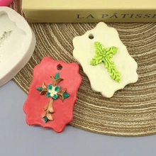 Detail of red and beige cross-shaped crafts next to a flexible silicone mold for DIY projects